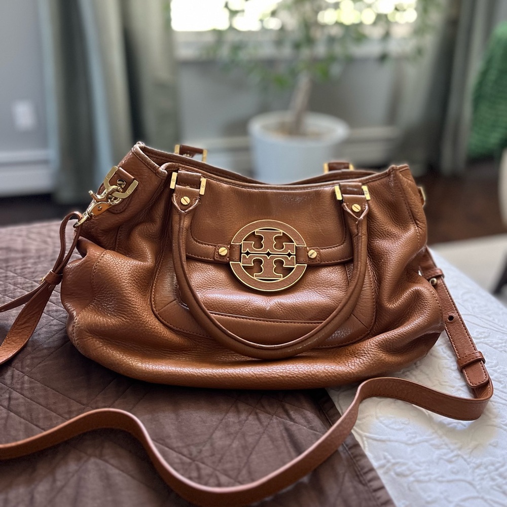 Tory Burch caramel colored, leather bag with handles and cross body straps.